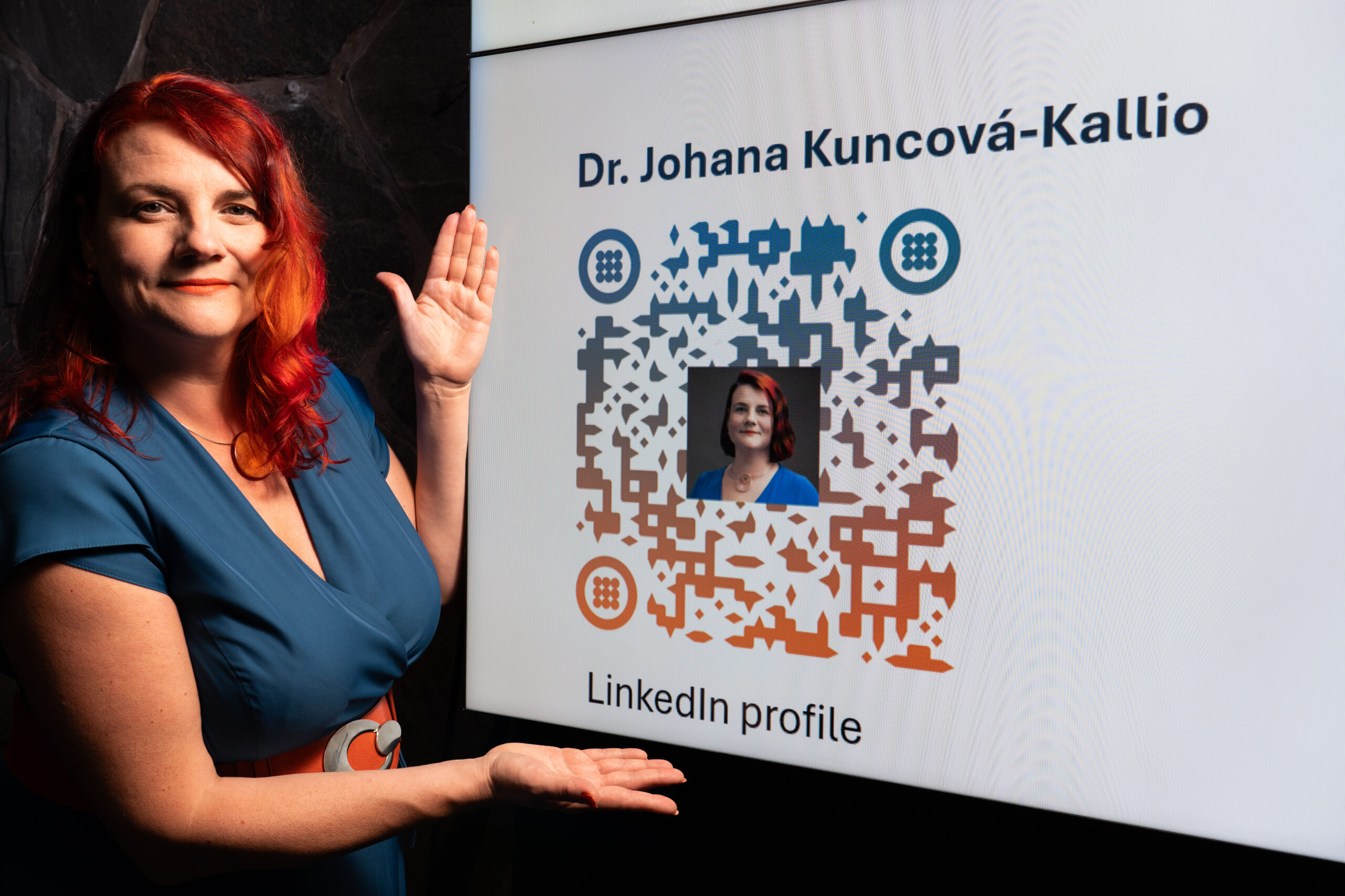 Linkedin QR code in front of Johana for contacting QR code to Linkedin profile